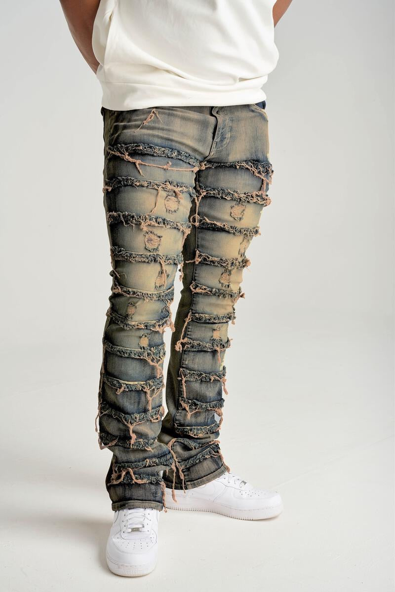 STRETCH STACK JEANS WITH FRAYED PATCH